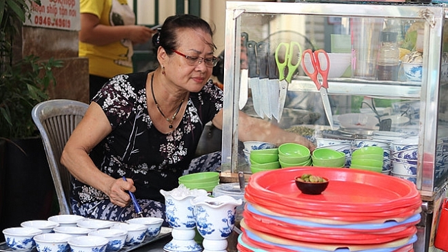 Crowded diner downtown Hanoi where buyer and sellers communicate by nonverbal means