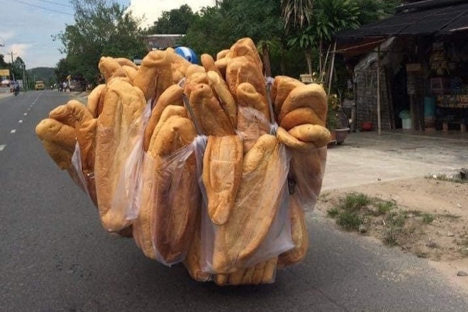 A man carrying bags of giant on his motorbike 