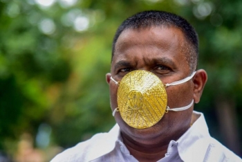 weird covid 19 style indian man wears gold face mask to shield from coronavirus