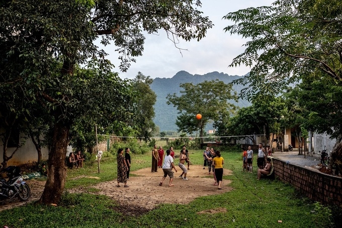 A group of people playing basketball in the residential area
