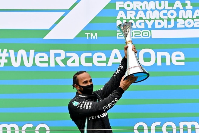 Hamilton raising his trophy after winning in Hungary 