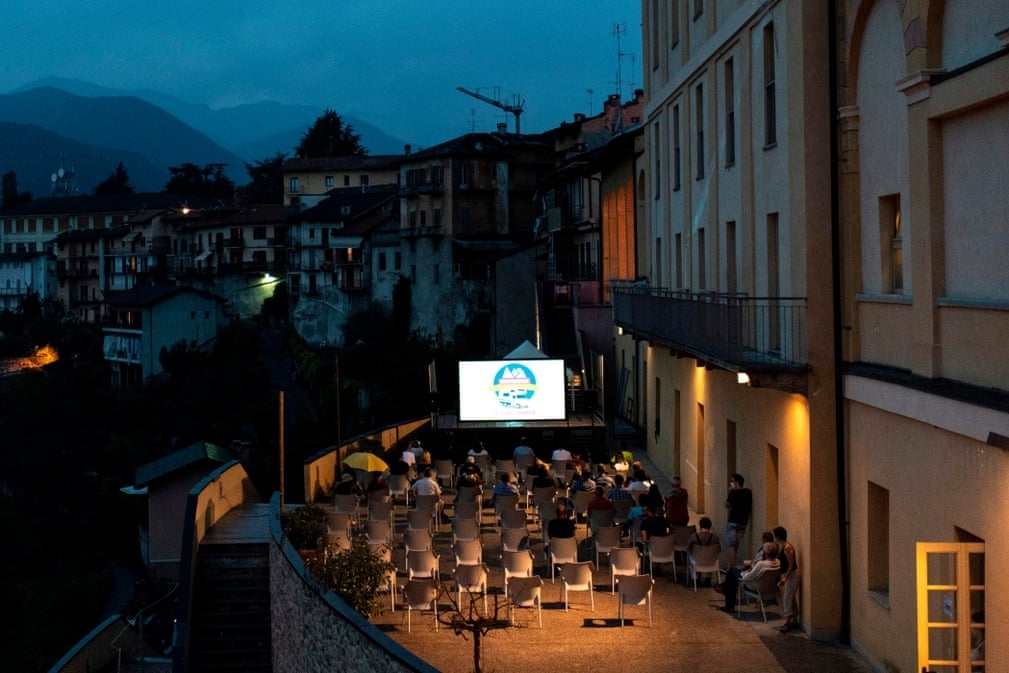 People watch movies outdoors in Italy  