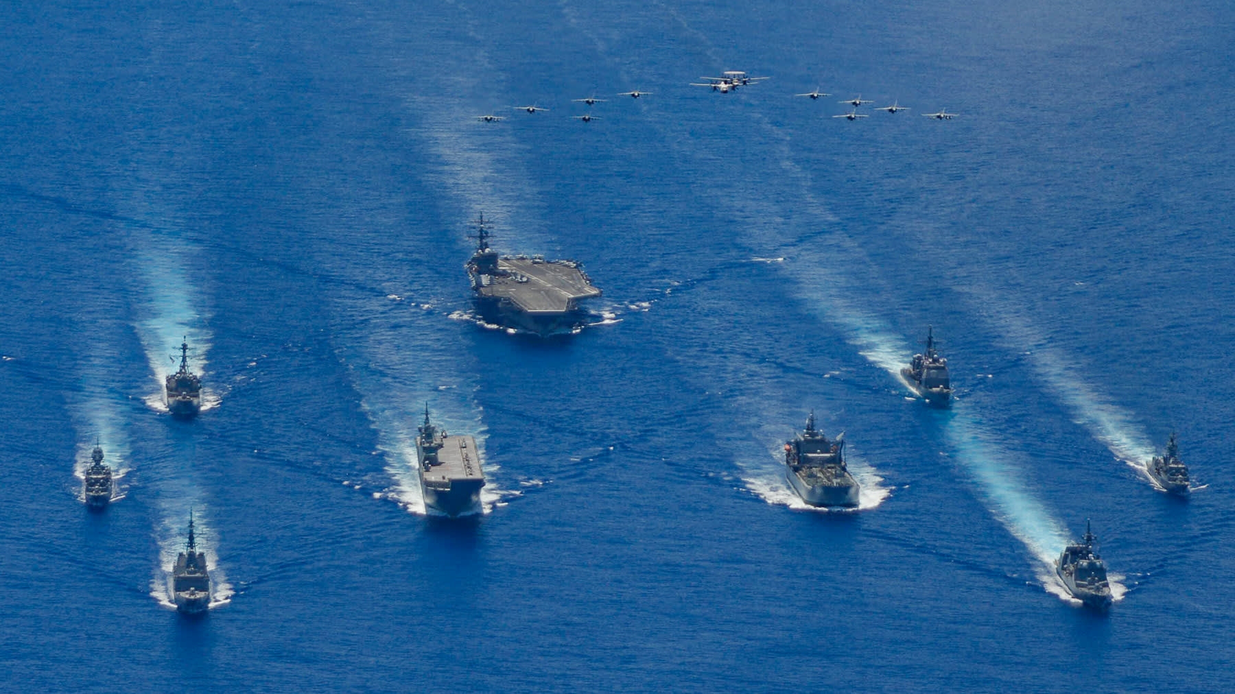 The ronald reagan carrier strike group and units from the japan maritime self-defense force and australian defense participate in trilateral exercises the philippine sea on july 21