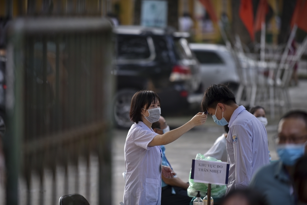 All students have their body temperature checked before entering the exam sites 