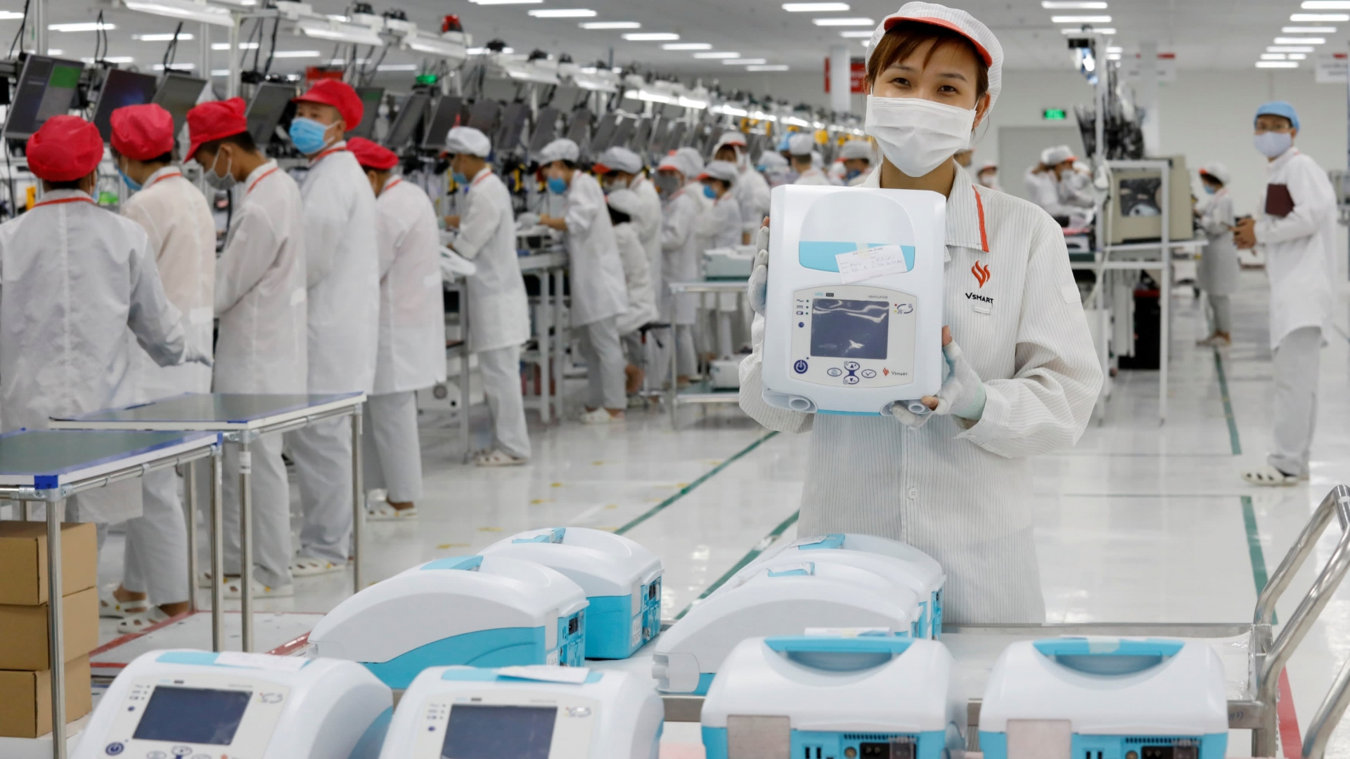 An employee displays a ventilator at a VinSmart factory near Hanoi