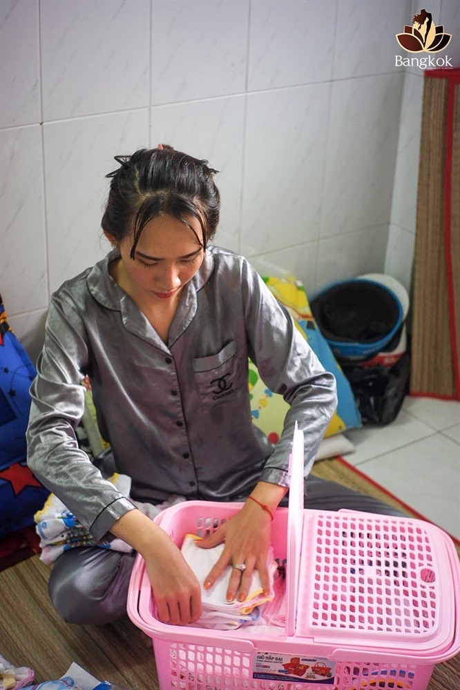 Minh Anh preparing clothes for her baby