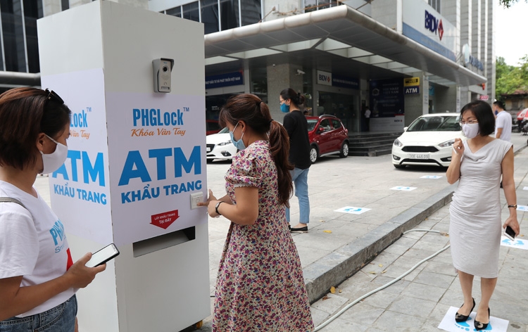 Free face mask atm with automatic facial recognition utility appears in hanoi