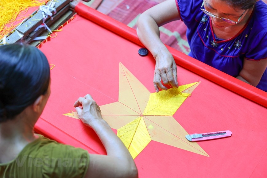 The village with 75 year tradition of embroidering national flags