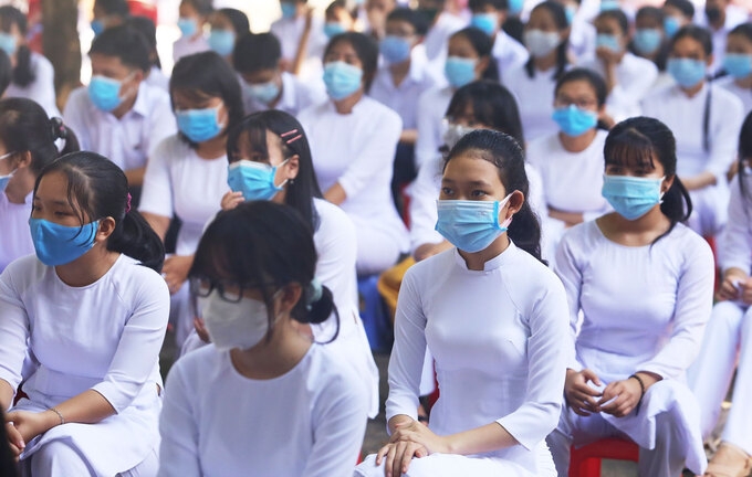 Students in Nguyen Binh Khiem high school must wear face masks while attending the ceremony 