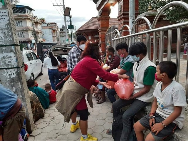 Poor Napalese get donated rice from Vo Thi Kim Cuong