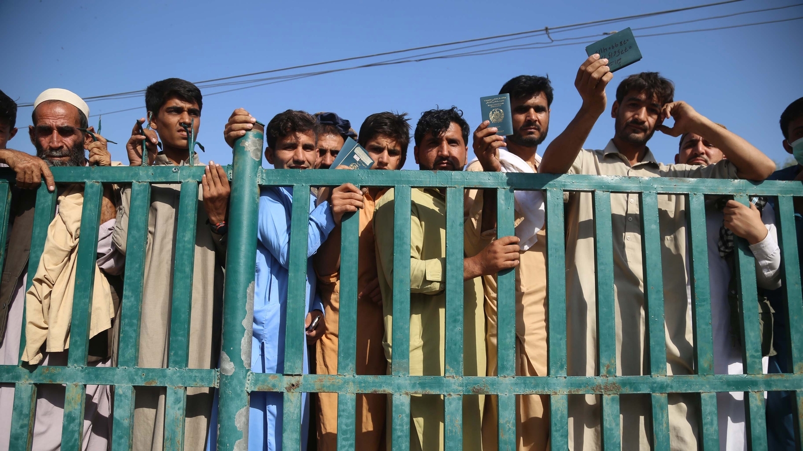 Afghans wait to apply for a visa at the Pakistani consulate after a stampede, in Jalalabad, Afghanistan