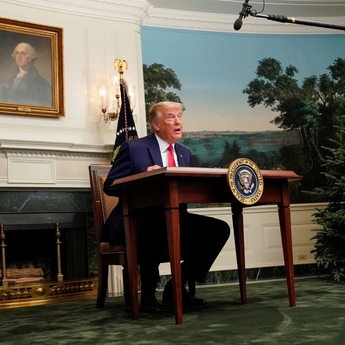 Trump was giving speech at a small table (Photo: Guardian) 