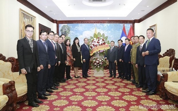 The delegation led by  Deputy Minister Nguyen Quoc Dung at Lao Embassy in Hanoi (Photo: Bao Quoc Te) 