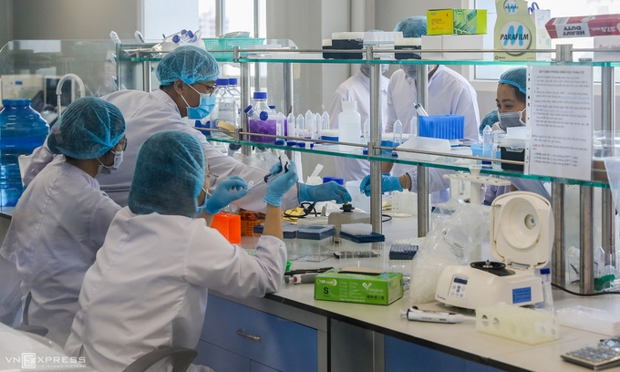 Employees of Nanogen Pharmaceutical Biotechnology JSC work in a molecular biology room to produce made-in-Vietnam vaccine to be tested on human, December 2020. (Photo: VNE) 
