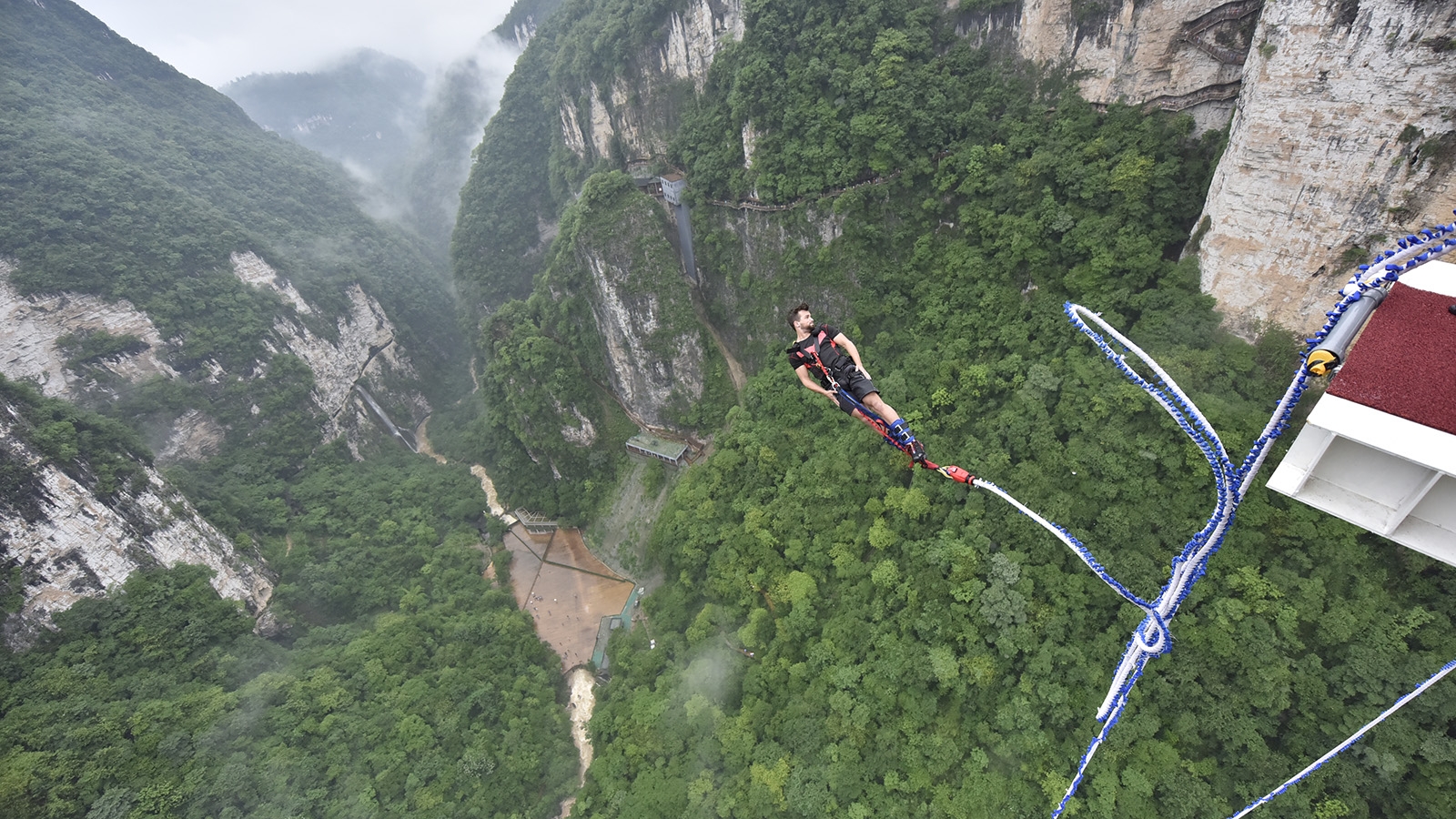 Thrilling bungee jumping from glass bottom bridge in Central China
