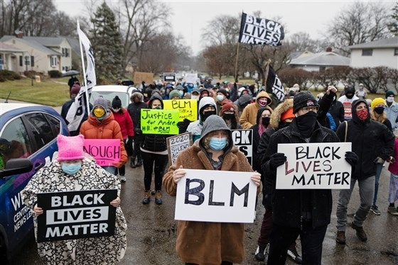 Protesters gather on Dec. 24, 2020 outside the home where Andre Maurice Hill, 47, was killed in Columbus, Ohio. (Photo: Reuters)  