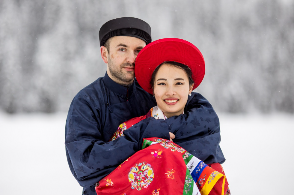 Vietnamese - Polish couple wearing Nguyen Dynasty costume for snowy wedding pictures in Canada