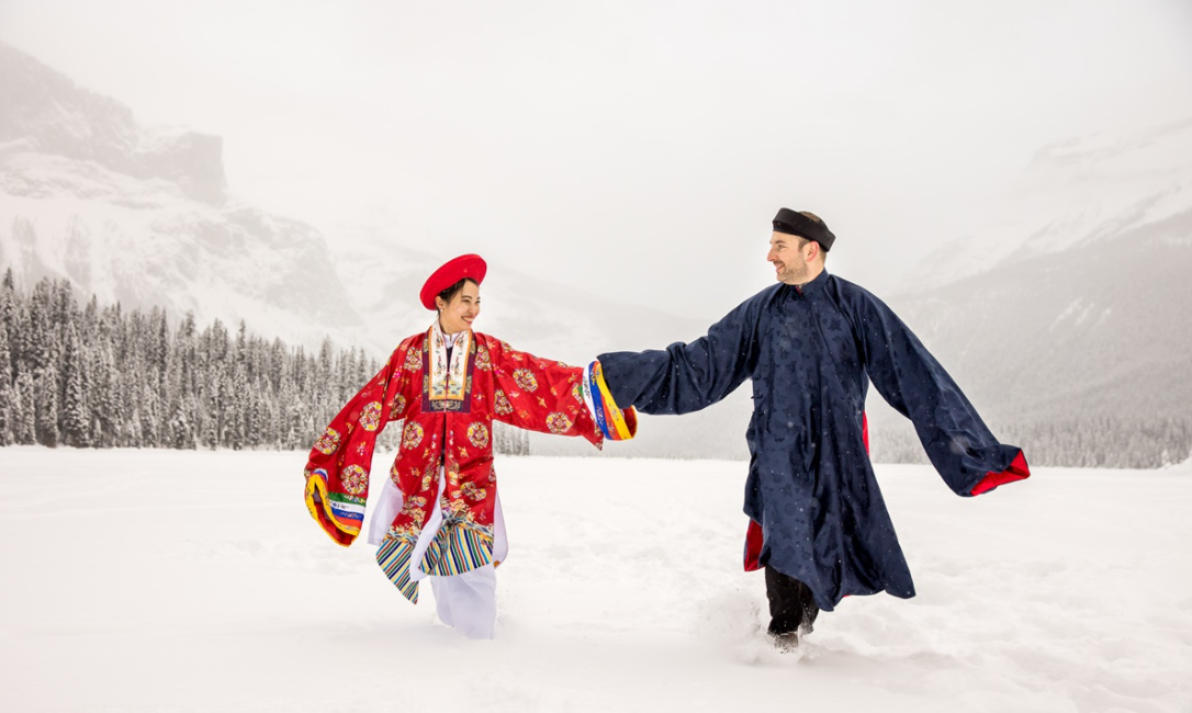 Vietnamese - Polish couple wearing Nguyen Dynasty costume for snowy wedding pictures in Canada