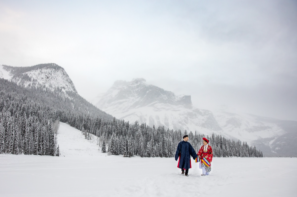 Vietnamese - Polish couple wearing Nguyen Dynasty costume for snowy wedding pictures in Canada