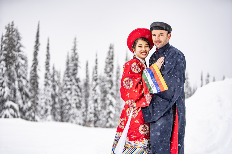 Vietnamese - Polish couple wearing Nguyen Dynasty costume for snowy wedding pictures in Canada