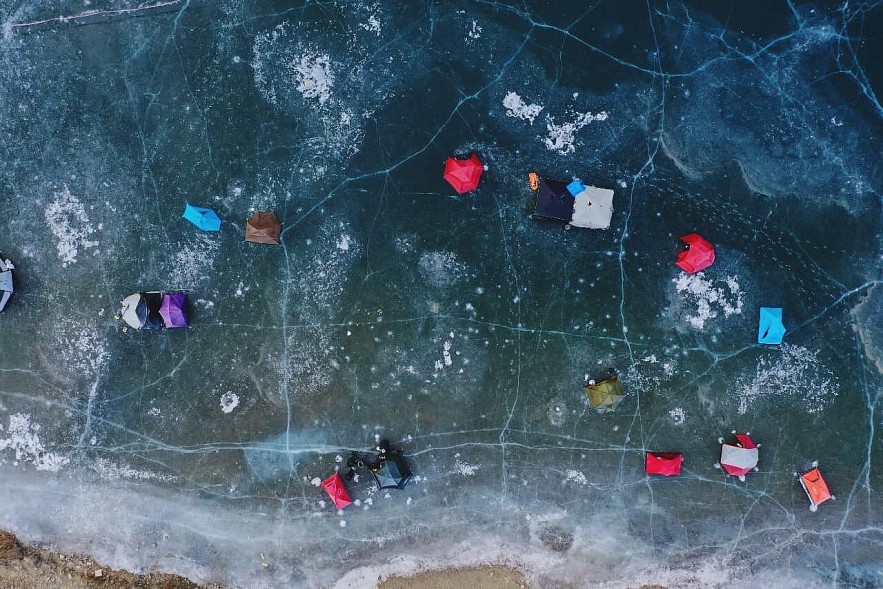 Vietnamese tourists camp on frozen river