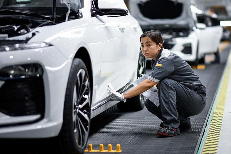 A worker operates the car assembly line at the new automobile plant of VinFast, Vietnam's first homegrown car manufacturer in Haiphong.