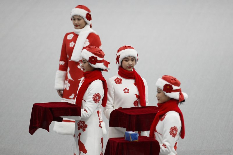 Chinese attendants dressed in winter costumes rehearse the award ceremony of the men's 500-meters race during a test event for the 2022 Beijing Winter Olympics at the National Speed Skating Oval in Beijing, Wednesday, April 7, 2021. The organizers of the 2022 Beijing Winter Olympics has started 10 days of testing for several sport events in five different indoor venues from April 1-10, becoming the first city to hold both the Winter and Summer Olympics. (AP Photo/Andy Wong)