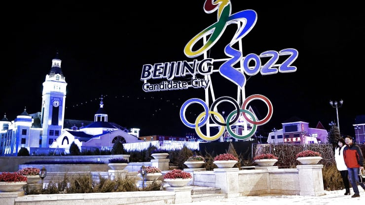 Chinese citizens walks past a sign for Beijing’s Winter Olympics in Zhangjiakou, Hebei Province, China. Lintao Zhang | Getty Images