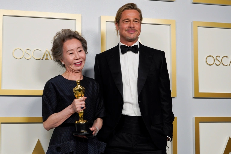 Yuh-jung Youn and Brad Pitt in the press room at the Academy Awards. (Photo by Chris Pizzello-Pool/Getty Images)