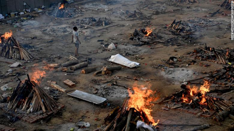 A man stands amid burning pyres of Covid-19 victims at a crematorium in New Delhi, India, on April 26. (Photo: CNN) 