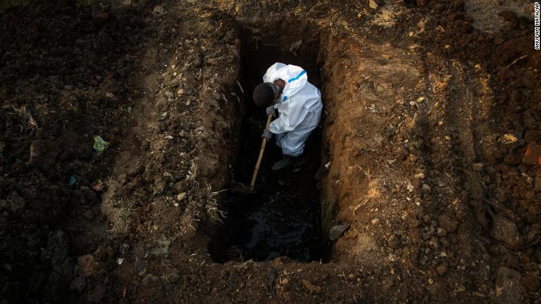 A man in protective suit digs earth to bury the body of a Covid-19 victim in Gauhati, India, on April 25. (Photo: CNN) 