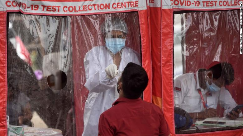 A healthcare worker collects swab samples at a Covid-19 testing center in Mumbai, India, on April 22. Photo: CNN