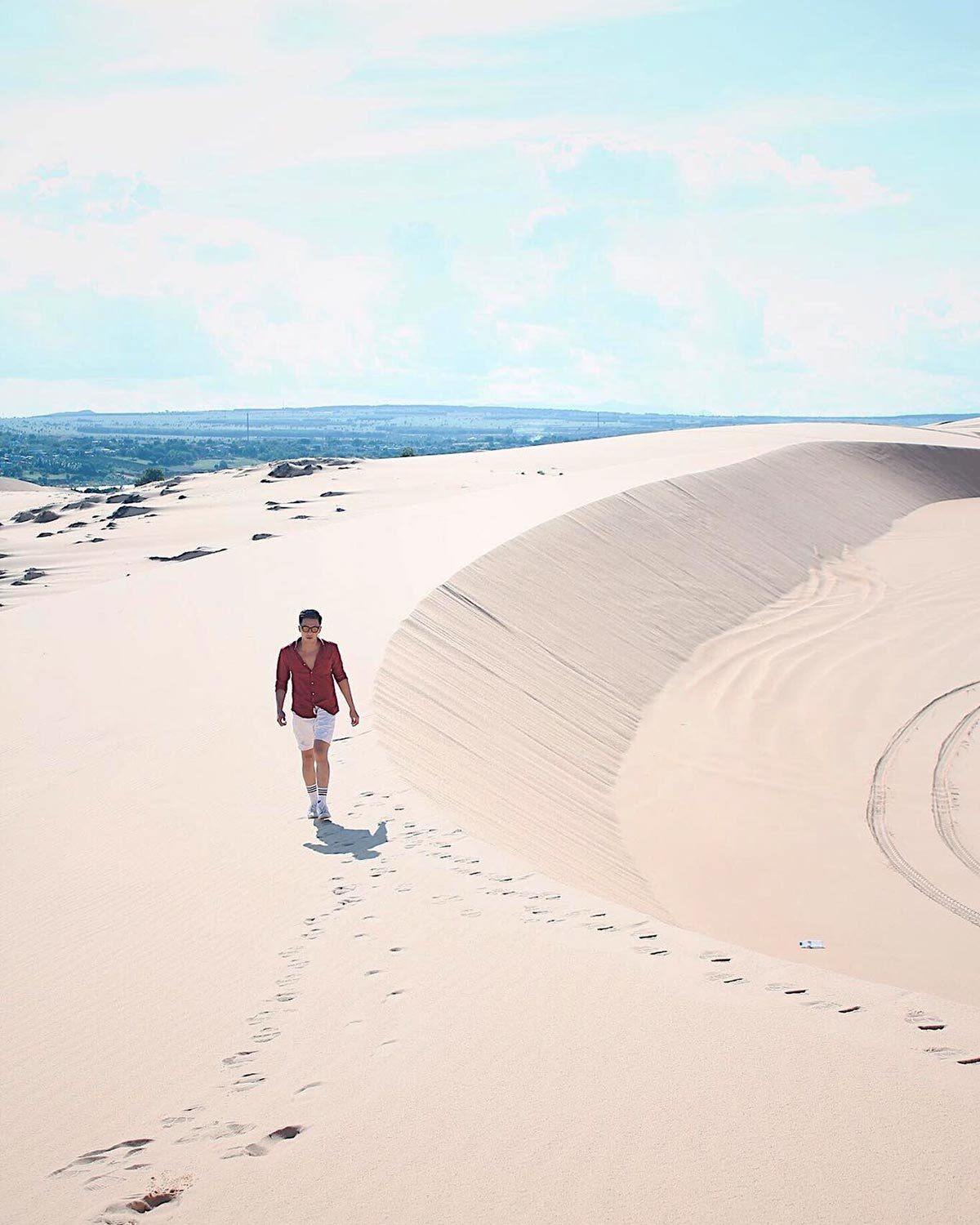 The sand dunes in Bau Trang are shaped by the wind from the sea into a desert-like hill. The tourists can walk on the sand dunes for sightseeing and taking photographs. Photo: Dang Duong 