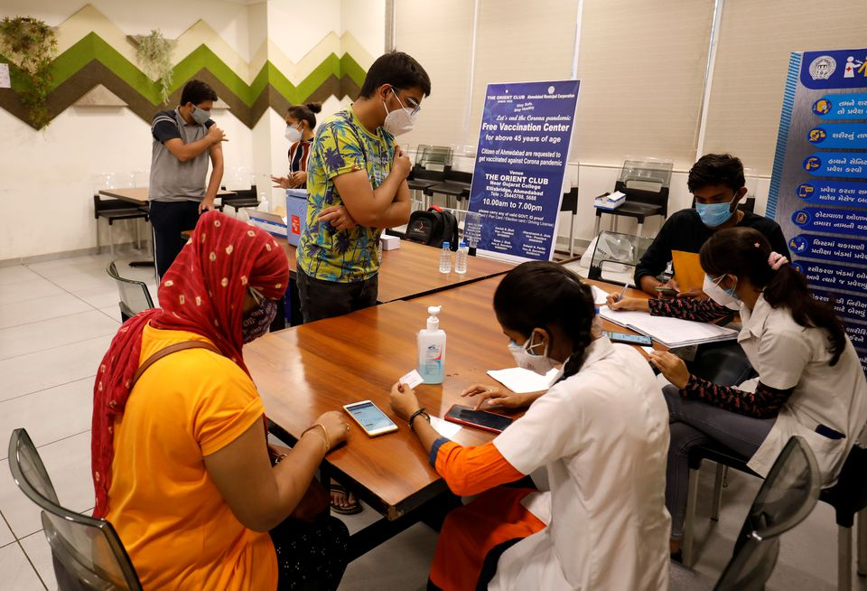 People get their names registered after receiving a dose of COVISHIELD, a coronavirus disease (COVID-19) vaccine manufactured by Serum Institute of India, at a vaccination centre in Ahmedabad, India, May 1, 2021. REUTERS/Amit Dave