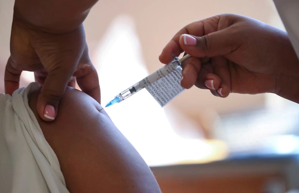 A healthcare worker receives the Johnson and Johnson coronavirus disease (COVID-19) vaccination at Khayelitsha Hospital near Cape Town, South Africa, February 17, 2021. REUTERS/Mike Hutchings