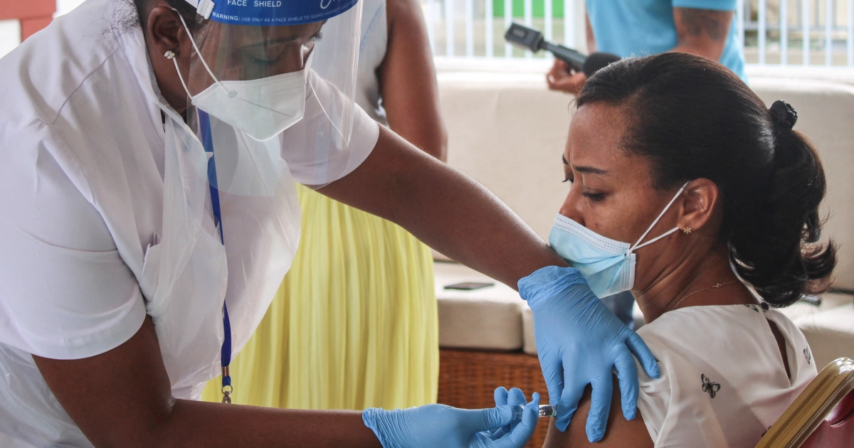 A medic administers a COVID-19 vaccine in the Seychelles. The WHO is reviewing the data after the health ministry found 37 percent of people testing positive for the disease in the last week had received both doses [File: Rassin Vannier/AFP]