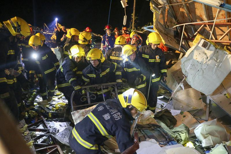 In this photo released by China's Xinhua News Agency, emergency personnel search through the wreckage of buildings destroyed by a reported tornado in Wuhan in central China's Hubei Province, early Saturday, May 15, 2021. Two tornadoes killed several people in central and eastern China and left hundreds of others injured, officials and state media reported Saturday. (Xiong Qi/Xinhua via AP)