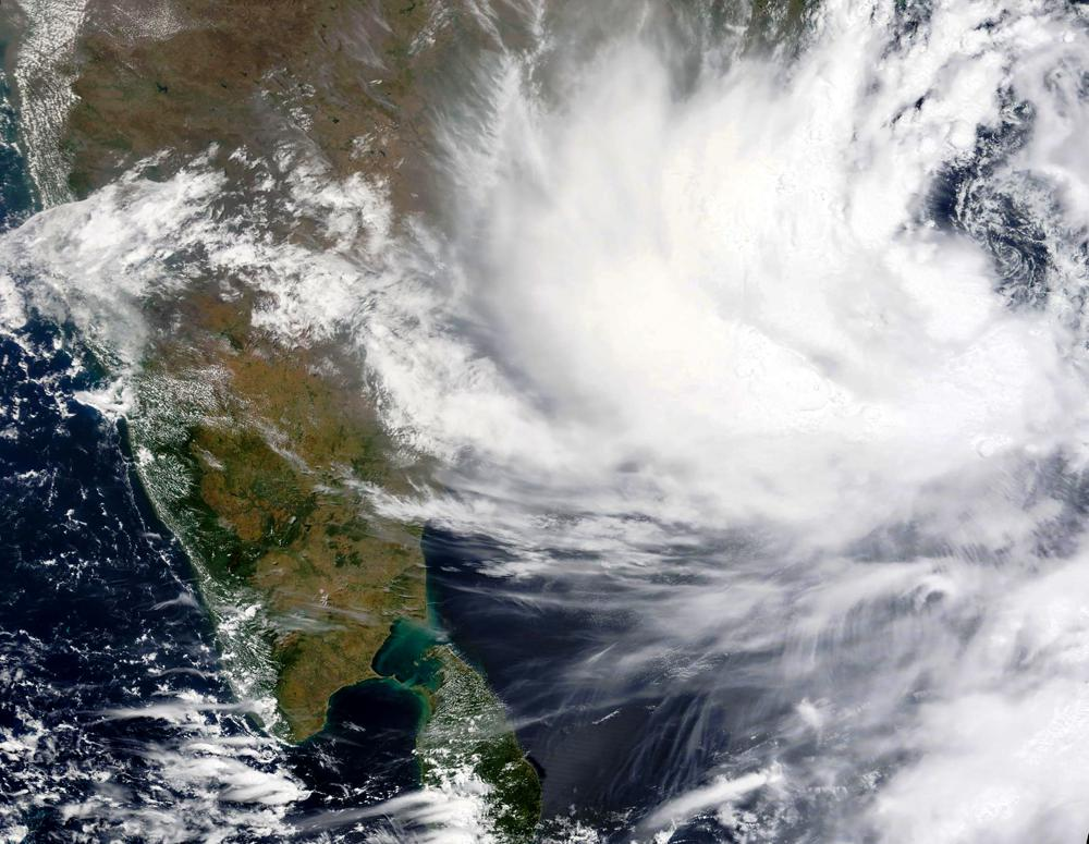 This Monday, May, 24, 2021, satellite image provided by NASA shows Cyclone Yaas approaching India's eastern coast. Yaas is expected to make landfall on Wednesday, May 26, 2021, and could pack sustained winds of up to 165 kilometers per hour (102 miles per hour), the India Meteorological Department said. It said the storm was forecast to hit the eastern states of West Bengal and Odisha, just days after a powerful storm battered the country's western coast and killed at least 140 people. (NASA Worldview, Earth Observing System Data and Information System (EOSDIS) via AP)