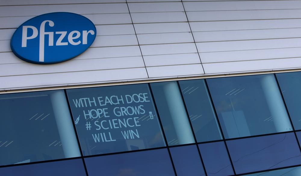 In this Tuesday, Feb. 23, 2021 file photo, a sign is pasted into an upper window at Pfizer manufacturing center in Puurs, Belgium. The European Union cemented its support for Pfizer-BioNTech and its novel COVID-19 vaccine technology, Saturday, May 8, 2021 by agreeing to a massive contract extension for a potential 1.8 billion doses through 2023. 