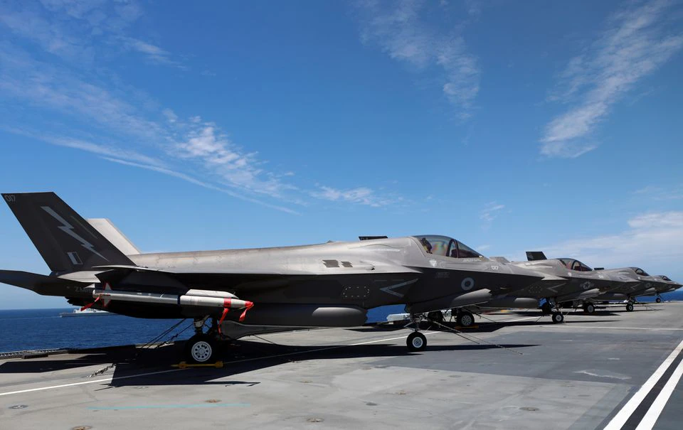 F-35B Lightning II aircrafts are seen on the deck of the HMS Queen Elizabeth aircraft carrier offshore Portugal, May 27, 2021. Picture taken through the window. REUTERS/Bart Biesemans