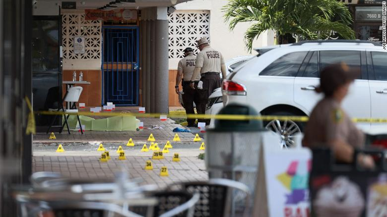 Miami-Dade police investigate Sunday near shell case markers on the ground. (Photo: CNN) 