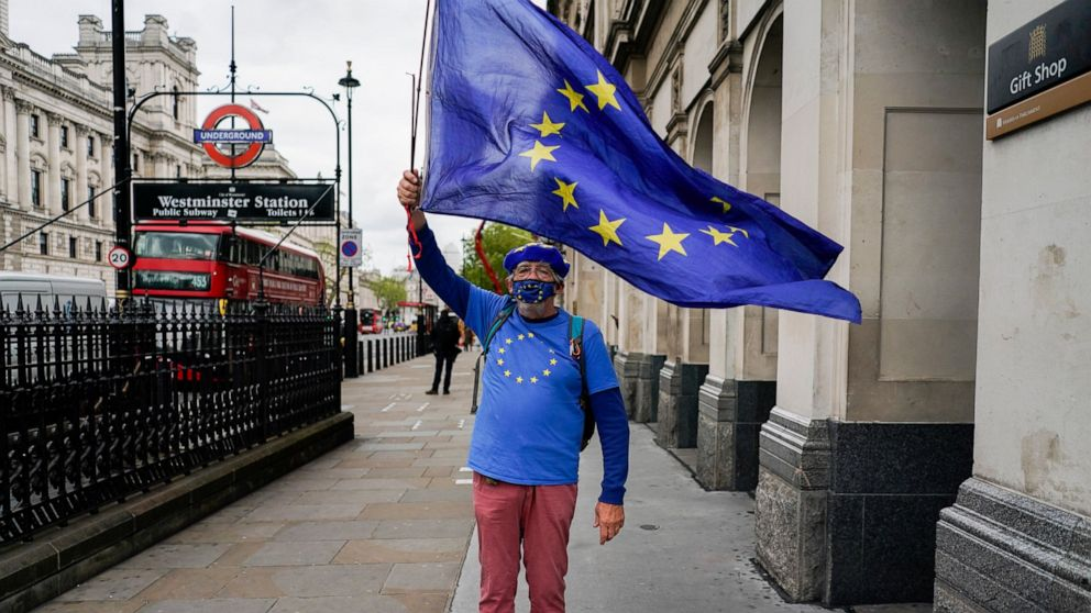 An anti-Brexit protester waves an EU flag, near Parliament Square, in London, Wednesday, May 26, 2021. (AP Photo/Alberto Pezzali)