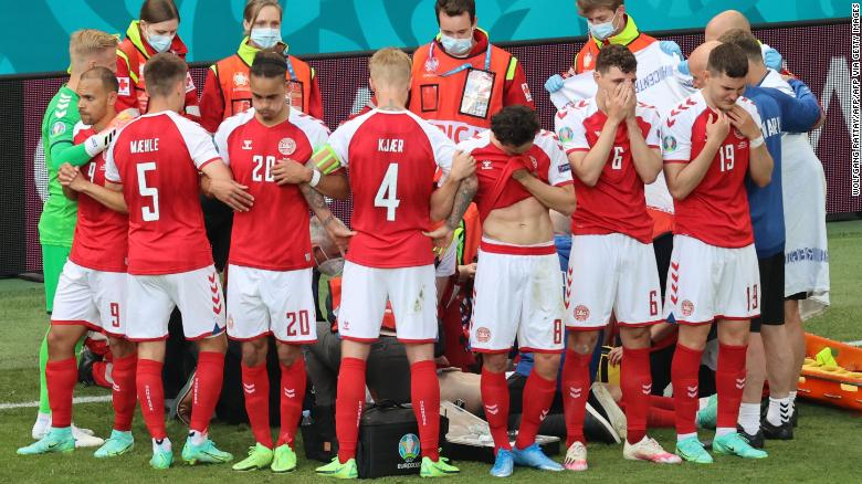 Denmark's players gather as paramedics attend to midfielder Christian Eriksen (not seen) during Saturday's match. Photo: CNN