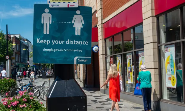 A sign reminding shoppers to stay distanced on Slough High Street. Photograph: Maureen McLean/REX/Shutterstock