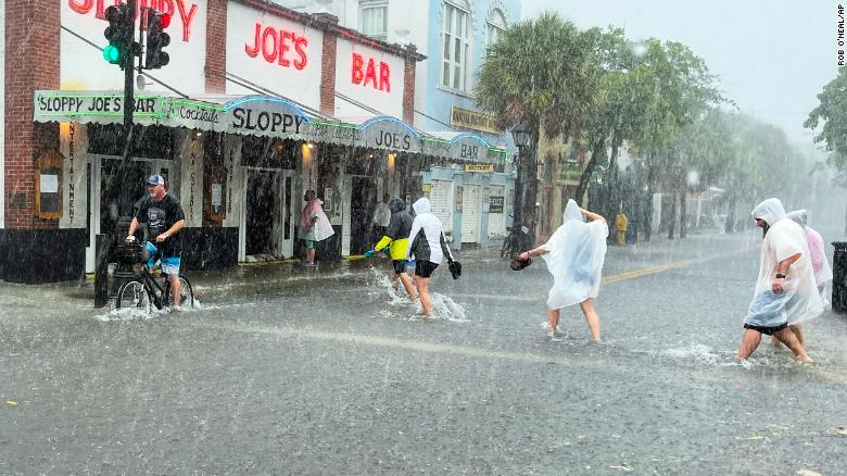 Determined visitors head to Sloppy Joe's bar while crossing a flooded Duval Street in Key West. Photo: CNN