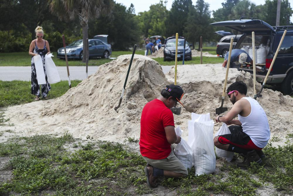 People fill sandbags to prep for storm Elsa at Walsingham Park, Monday, July 5, 2021 in Seminole, Fla. (Arielle Bader /Tampa Bay Times via AP)