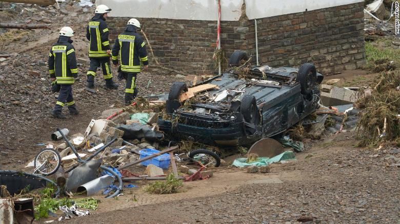 Deadly flooding in western Europe Firefighters walk past a car that was damaged by flooding in Schuld, Germany. Photo: CNN 