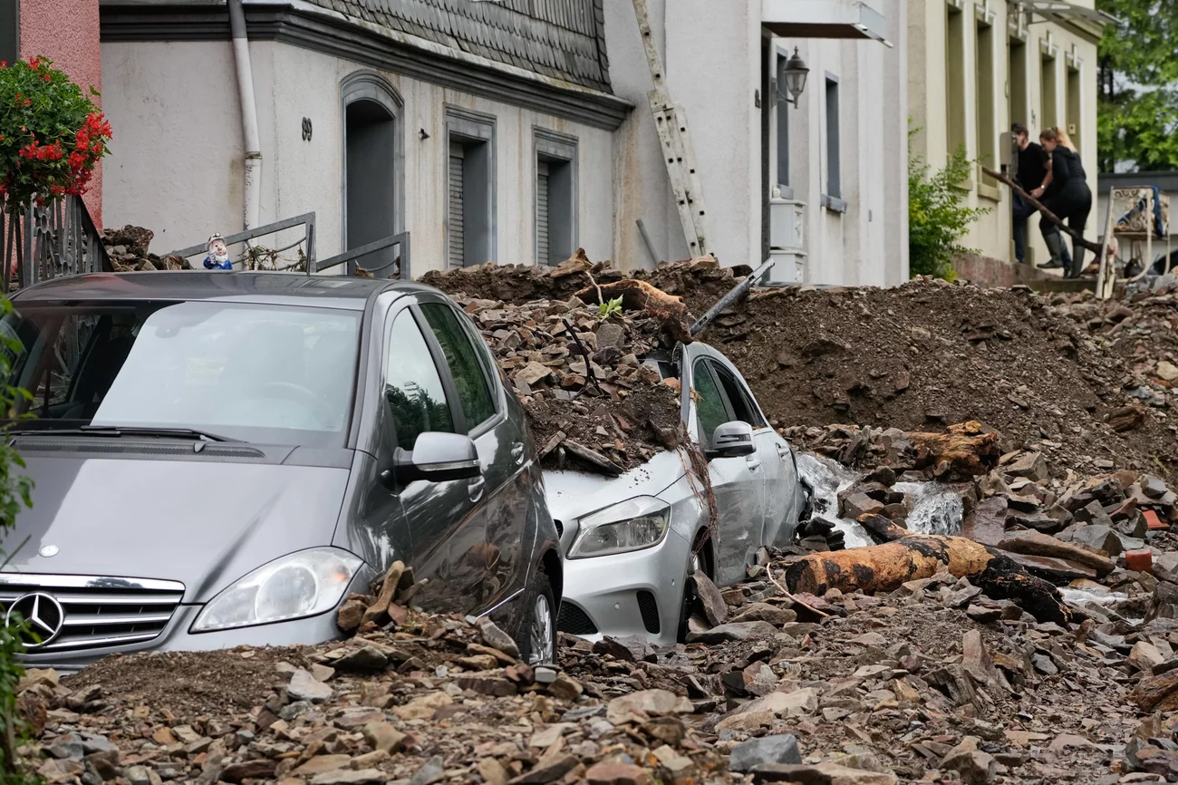 Cars are covered with debris brought on by flooding from a nearby river on Thursday in Hagen, Germany. Martin Meissner/AP