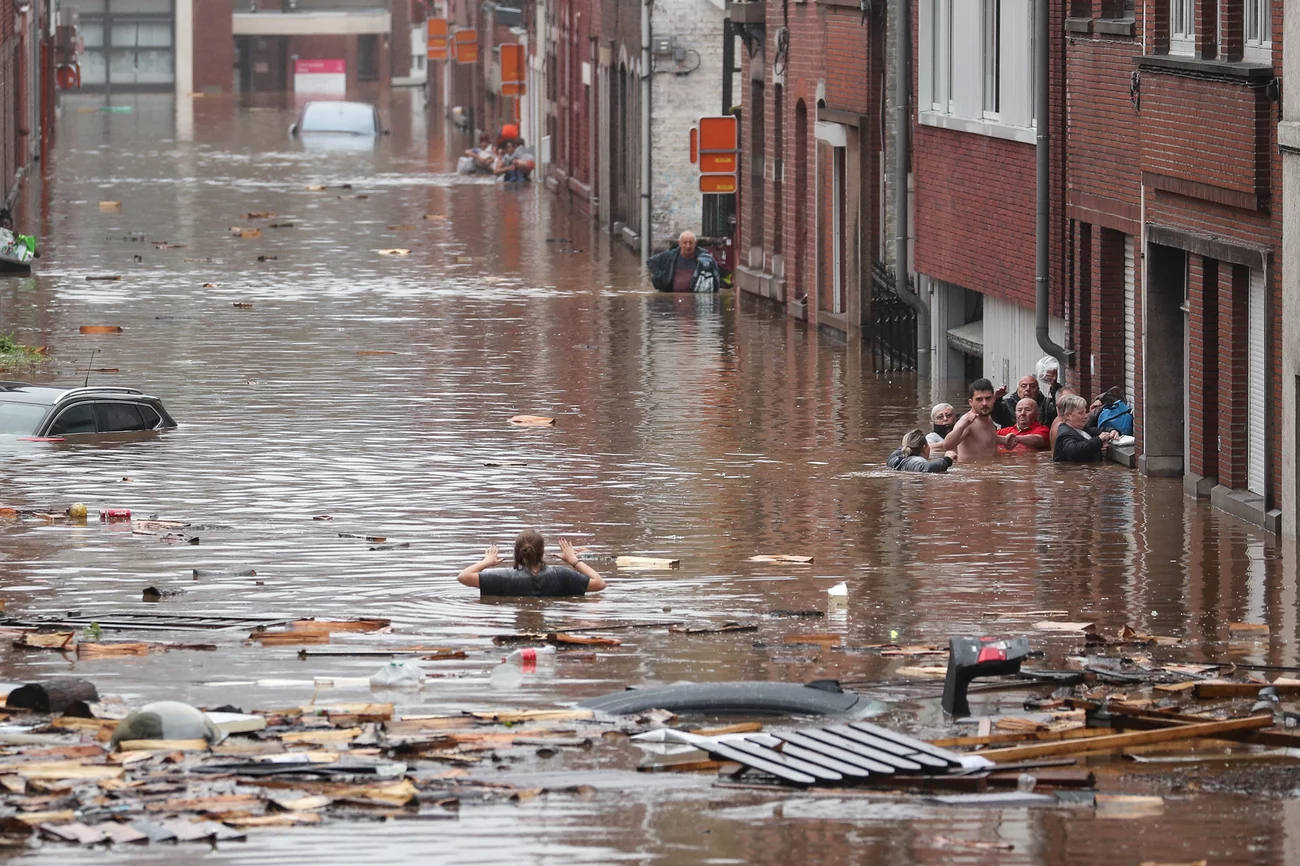 A woman tries to move in a flooded street following heavy rains Thursday in Liège, Belgium. Bruno Fahy/Belga/AFP via Getty Images