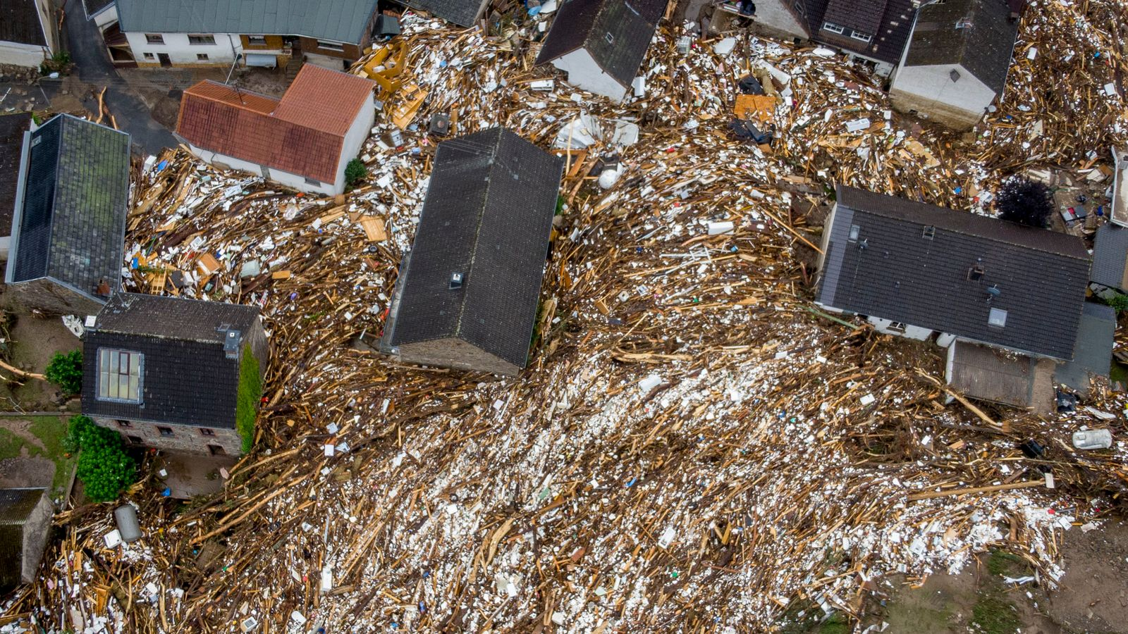 Trees and other detritus were left between houses in Schuld, Germany. Pic: Associated Press